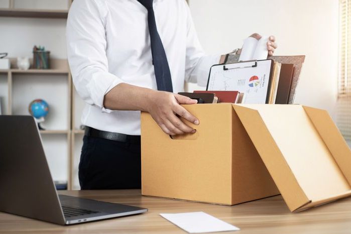 Resignation Businessmen are gradually packing personal boxes and resignation letters. Concept of unemployment, resignation, big resignation