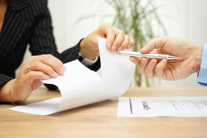 Woman tearing apart agreement