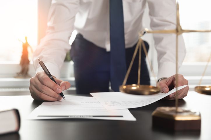 Man in office handwriting a letter