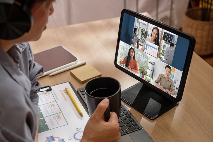 asian woman video conference business meeting with colleague online with tablet at home