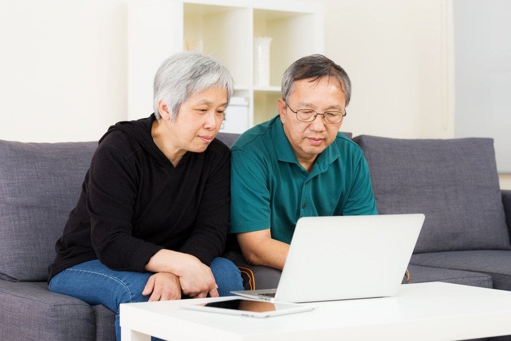 Asian old couple using laptop-1