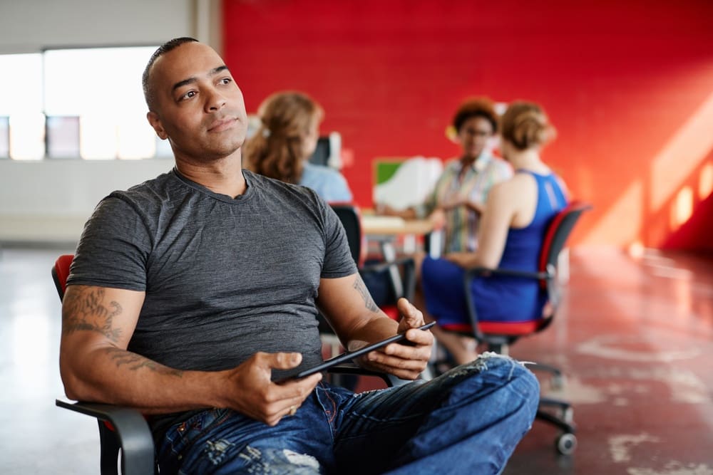 A man sitting in a chair in an office.