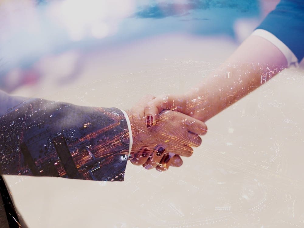 Double exposure design. Business partners concept with businessman and businesswoman handshake at modern office indoors-1