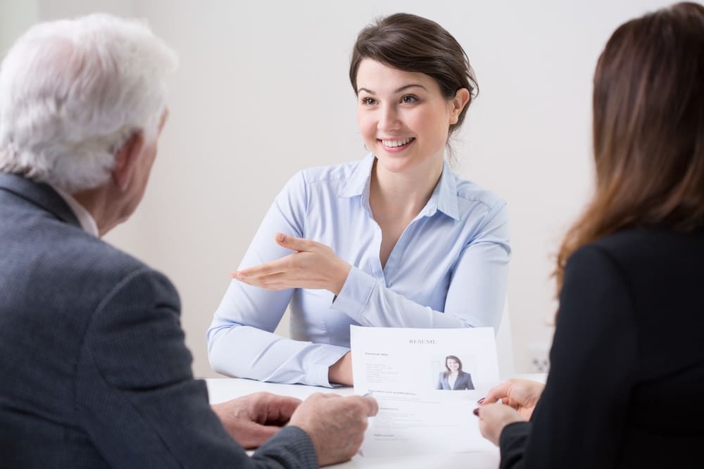 A woman is talking to a man at a job interview.