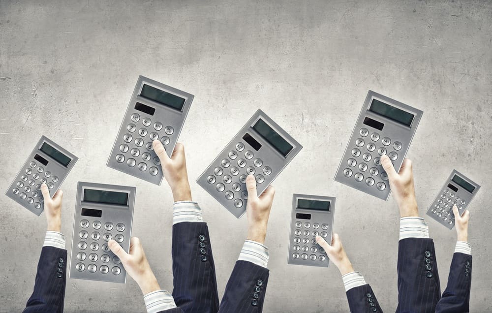 Many hands of business people holding calculators.jpeg