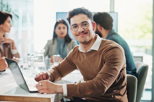 Business man, portrait and laptop in meeting with website research, proposal and planning at finance job. Office, accountant or online bookkeeper with computer for company revenue, growth and news