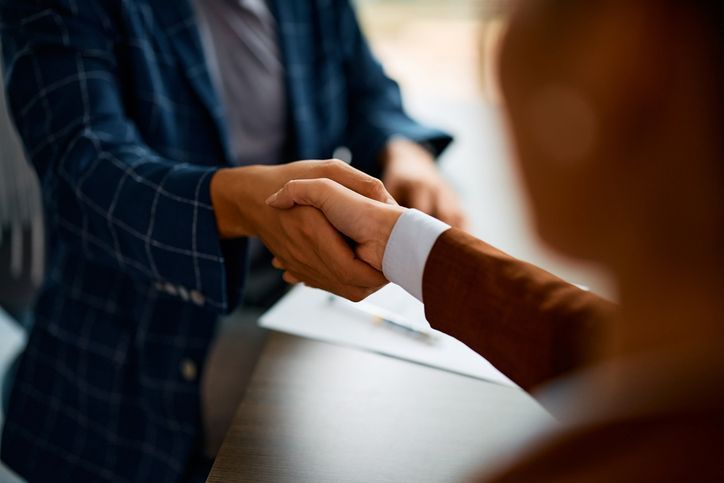 Close up of business people shaking hands in the office