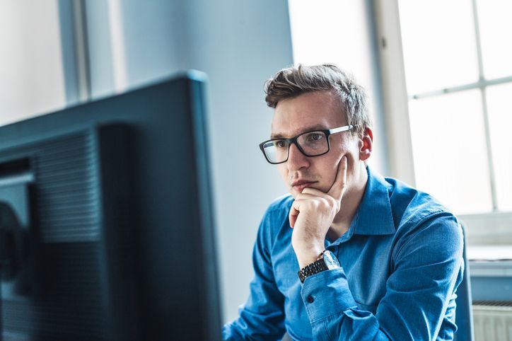 man looking at his computer screen