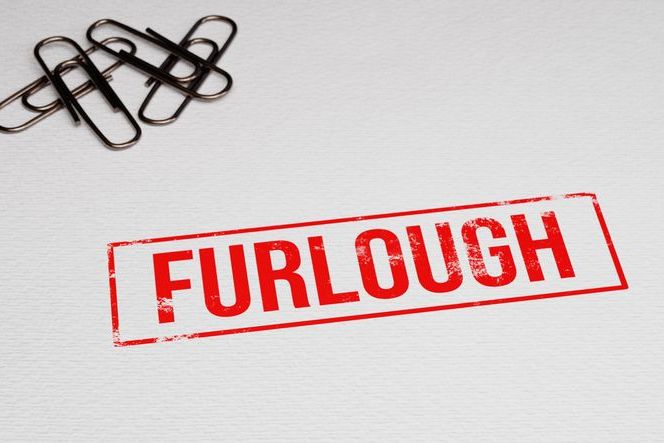 the word Furlough stamped on a white piece of paper with paper pins in the left corner