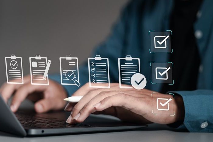 Businessman using laptop with document online for approve quality assurance and ERP management, Quality management with assurance, Quality control and improvement.