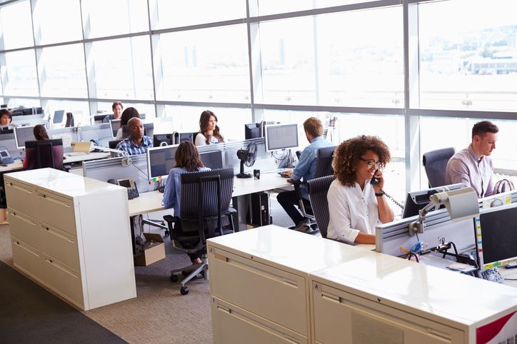 Casually dressed workers in a busy open plan office